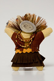 a small doll-like fetish with a headdress of feathers, beaded necklace, mask and dress made of leather.